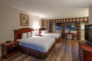Postel nebo postele na pokoji v ubytování Studio City Court Yard Hotel