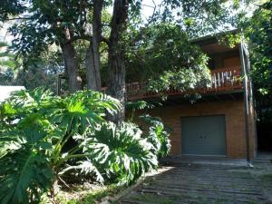 a house with a tree and a garage at Haven in Point Lookout