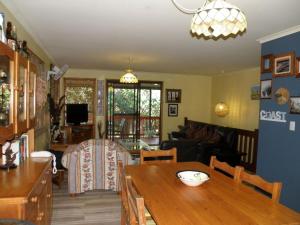 a living room with a table and a dining room at Haven in Point Lookout