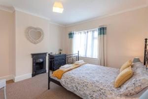 a bedroom with a bed and a fireplace at Silver Stag Properties, Charming 2 BR House in Leicester