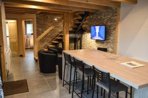 a dining room with a large table and chairs at Chalet Les Camélias SPA in Gérardmer