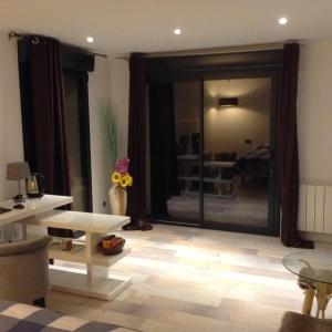 a living room with a large sliding glass door at Intime et tranquille in Vernouillet