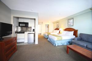 a hotel room with a bed and a couch at Flagship Oceanfront in Ocean City