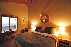 Un dormitorio con una cama grande y una ventana en Villa Winglo en Rand Rifles