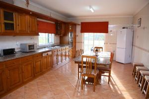 a kitchen with a table and a white refrigerator at Casa Sousa in Lagos