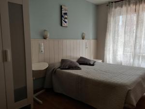 A bed or beds in a room at Hostal Campoamor