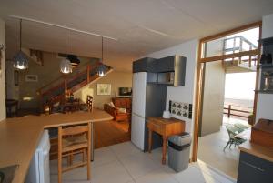a kitchen and living room with a view of the ocean at Villa Winglo in Rand Rifles