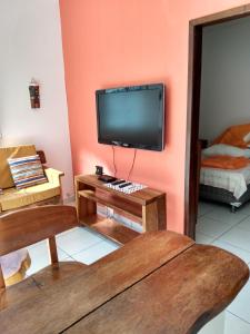 a living room with a flat screen tv on a wall at marés de milagres in São Miguel dos Milagres