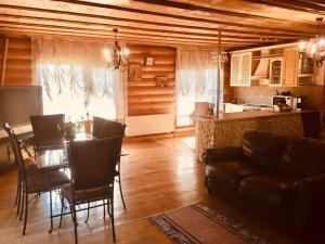 a living room with a dining table and a kitchen at Будинок в горах in Polyana