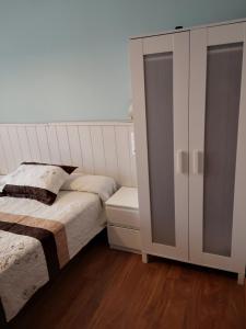 A bed or beds in a room at Hostal Campoamor