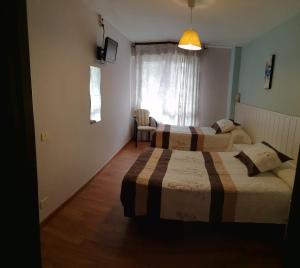 A bed or beds in a room at Hostal Campoamor