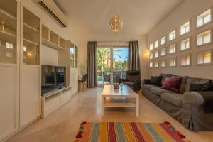 a living room with a couch and a tv at Beautiful Cosy 3 bedroom townhouse in South Marina in Hurghada