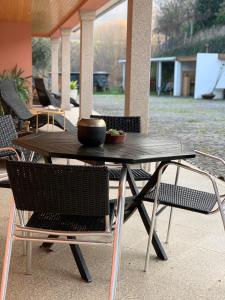 a wooden table with chairs and a bowl on top at Quinta das Ameixas - Country & Nature in Arouca