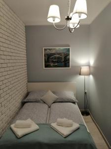 Ένα ή περισσότερα κρεβάτια σε δωμάτιο στο Cicha Przystań - Apartamenty Wyspa Solna