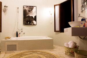 uma casa de banho com uma banheira e um lavatório em Estalagem Camburi em Camburi