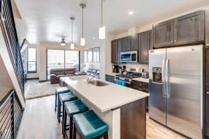 a kitchen with stainless steel appliances and a living room at New Luxury Villa #268 With Rooftop Hot Tub & Great Views - 500 Dollars Of FREE Activities & Equipment Rentals Daily in Winter Park