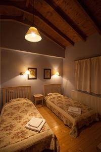 a bedroom with two beds with towels on them at Amadryades Boutique Hotel in Alatopertra