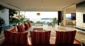 a living room with a couch and a large window at The heights penthouse 3bedroom A2 in Kata Beach