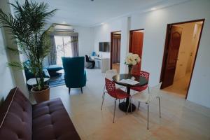 a living room with a couch and a table and chairs at Segara Residencias in Olongapo