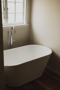 a bath tub in a bathroom with a window at Mt John Homestead in Lake Tekapo