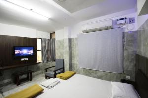Postel nebo postele na pokoji v ubytování Hotel Joyce
