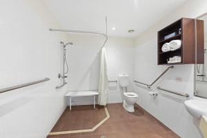 a bathroom with a toilet, sink, and shower at Mantra Quayside Port Macquarie in Port Macquarie
