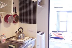 A kitchen or kitchenette at Nomad Apartment Stay