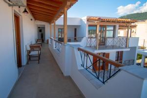 a balcony of a house with a table and chairs at Villa Fantasia in Skiathos