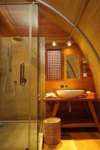 a bathroom with a glass shower and a sink at Templation Hotel in Siem Reap