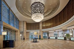 a large lobby with a large chandelier in a building at Pullman Wuxi New Lake in Wuxi
