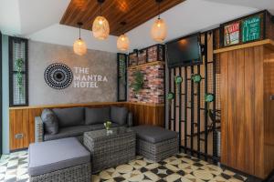 a lobby of a hotel with a couch and a table at The Mantra Hotel Kata Noi in Kata Beach