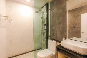 a bathroom with a sink and a toilet and a shower at The Mantra Hotel Kata Noi in Kata Beach
