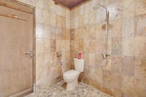 a bathroom with a toilet and a shower at RedDoorz at Omah Kayu Homestay Yogyakarta in Yogyakarta