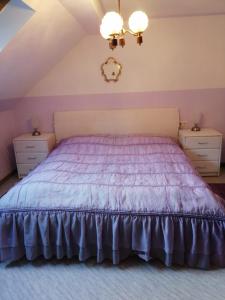 a bedroom with a purple bed with two night stands at Appartmenthaus Kern in Aigen im Mühlkreis