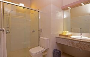 a bathroom with a shower and a toilet and a sink at Adaaran Club Rannalhi - All Inclusive - 45 Minutes away from Male by Speedboat in South Male Atoll