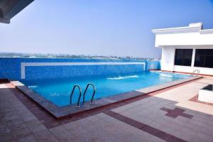 a swimming pool with a pair of sandals in it at AVS Imperiaa Karaikal in Karaikal