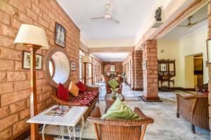 a living room with a brick wall at Karni Bhawan Heritage Hotel Jodhpur in Jodhpur
