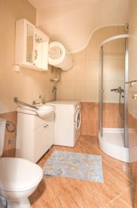 a bathroom with a toilet sink and a shower at Bologna Apartments in Budva +52 photos