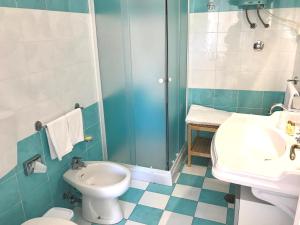 a bathroom with a toilet, sink, and tub at La Reginella Capri in Capri
