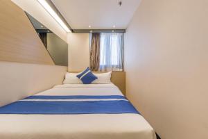 En eller flere senger på et rom på Lumine Hotel