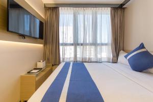 En eller flere senger på et rom på Lumine Hotel