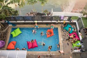 an overhead view of people in a pool at a resort at Mad Monkey Bangkok in Bangkok