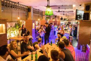 a group of people sitting at tables in a restaurant at Mad Monkey Bangkok in Bangkok +48 photos