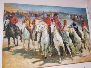 a painting of a group of men riding horses at SUITE-Junior -Villa HÉLÈNE - Montpellier Sud - aéroport- PISCINE Privée-2mn des plages in Pérols