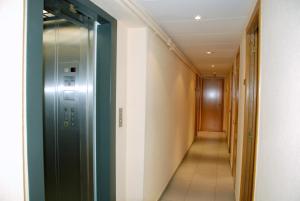 a corridor of a hallway with a door and a walkway at Hotel Goya in Lleida
