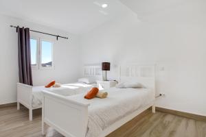Postel nebo postele na pokoji v ubytování Ático deluxe Corralejo centro