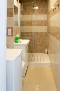 a bathroom with a sink and a shower at bonApartments in Warsaw