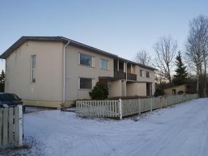 a white house with a fence in the snow at Saaremäe in Otepää