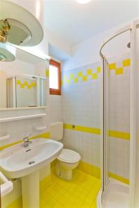 a bathroom with a sink and a toilet and a shower at Ca'Costanza in Bibione +58 photos