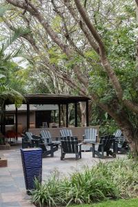 a group of chairs sitting on a patio at Emdoneni Lodge in Hluhluwe
